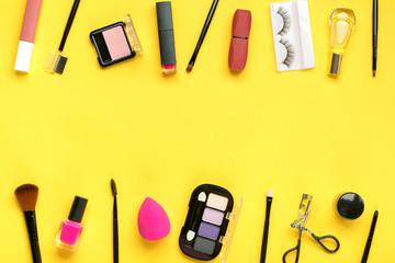Set of professional decorative cosmetics, makeup tools and accessory of trendy pink color isolated on yellow background Flat lay Top view