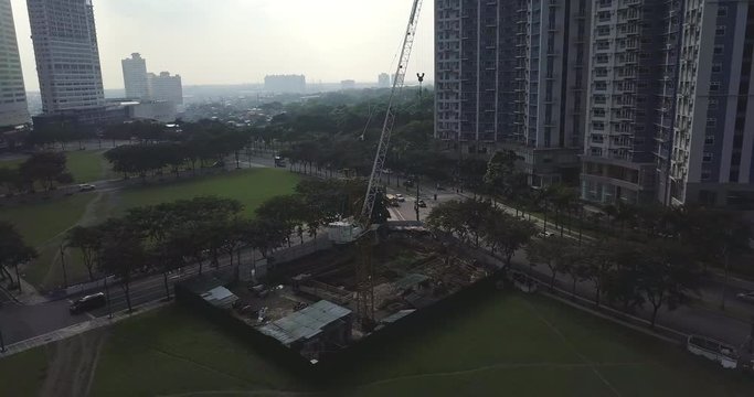 Panel aerial flight over construction site.  Crane close up. Drone, 4K. 

Frame rate: 23.98
Video Codec: ProRes 422HQ
Bonifacio Global City, BGC
Manila, Philippines