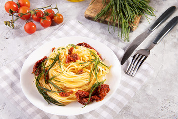 Spaghetti with agretti, a spring vegetable from Italy, and sun dried tomatoes and ingredients and...