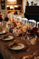 wedding table setting for a dinner with flowers and candles