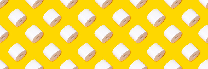 A roll of white toilet paper on a yellow background. Quarantine concept, shortage