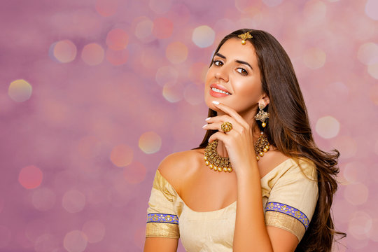 Fashionable Portrait of beautiful indian girl. beauty portrait. Young hindu woman model with kundan jewelry set. Close up. Traditional India costume lehenga choli or sari. make-up. 