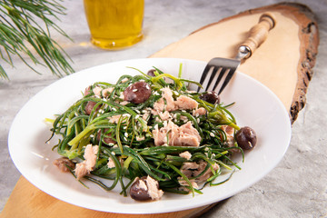 Light salad with agretti, a spring vegetable from Italy, tuna, black olives and olive oil for slimming and weight loss