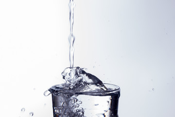water falling into a clear glass