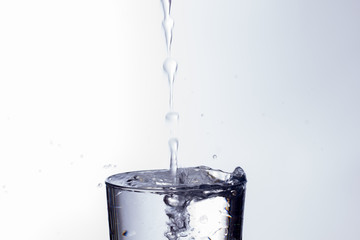 water falling into a clear glass