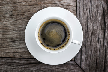 A cup of coffee on wooden background