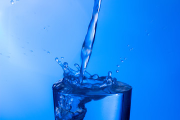 water falling into a clear glass