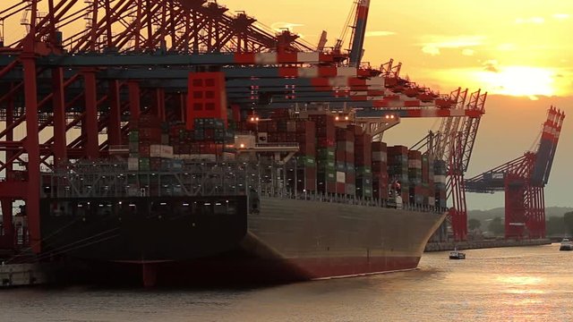 Container ship loading and unloading at sunset in the port of Hamburg / Germany
Wide angle shot, back light, slow zoom