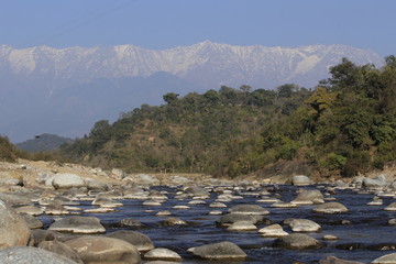 Colourful landscape with high Himalayan mountains, beautiful calm river, green forest, blue sky. ...