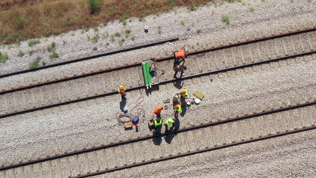 Railroad workers repairing a broken track, Top down aerial view.