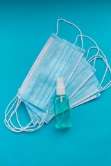 Hand sanitizer alcohol gel Antiviral protection and medical surgical masks with the standard for the prevention of coronavirus infection COVID-19. Medical protection on a blue background. 