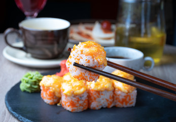 A sushi held with chopstick. Close up view. © futuristman