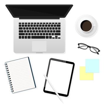 Laptops, tablets, glasses and notebooks in a top view That was placed on the blue desk. Home working ideas.