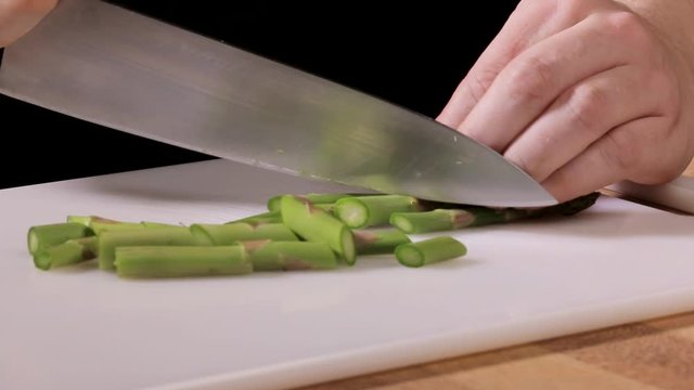 woman chef cutting asparagus
