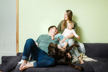 Stay home together concept, young happy family with kid and dog