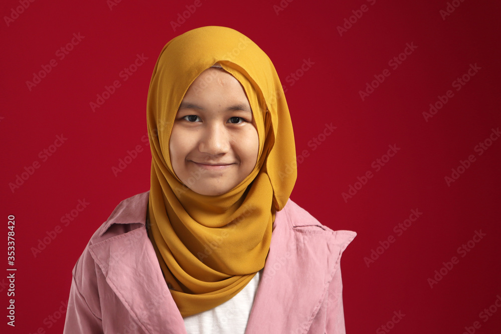 Wall mural portrait of young happy confident muslim teenage girl wearing hijab looking at camera and smiling ch