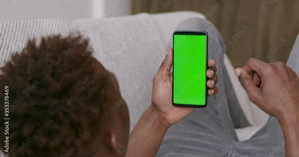 Poster african guy browsing on cellphone with chroma key screen