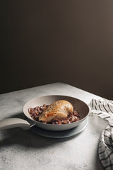 chicken breast in the pan, on caramelized red onion