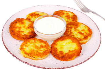 Vegetable marrow pancakes with white sauce. Photo