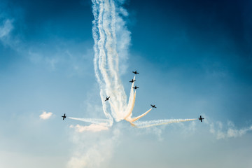 Formation of air planes on the blue cloudy sky during the airshow