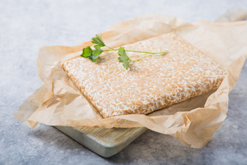 Slice of tempeh  or tempe made of fermentation process that binds soybeans, is traditional food...