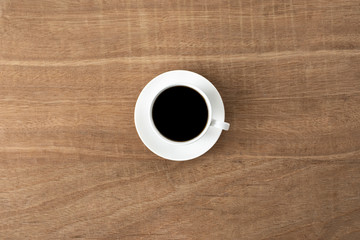 black coffee in a coffee cup top view isolated on wood background. with clipping path.