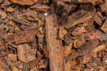 Old square and round rusty steel pipes piled up outdoor. Square Pipes of rusted metal structure texture material metal.