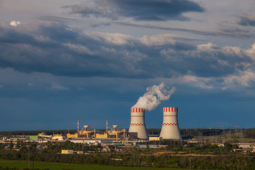 Cooling towers of a nuclear power plant in the light of the sunset and clouds