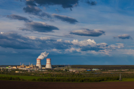 Landscape cooling towers of a nuclear power plant in the light of the sunset