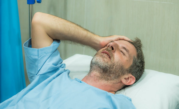 Scared And Worried Man In Pain At Hospital Room - Attractive Injured Man Lying On Bed Suffering Painful Problem Sick And Stressed After Suffering Accident Or Serious Disease