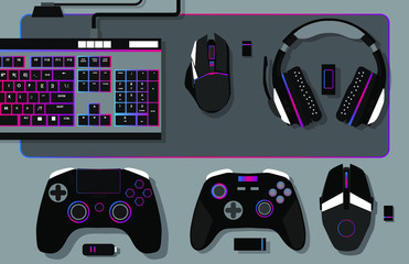 gamer workspace concept, top view a gaming gear, mouse, keyboard, joystick, headset, mobile joystick, in ear headphone and mouse pad on black table background.