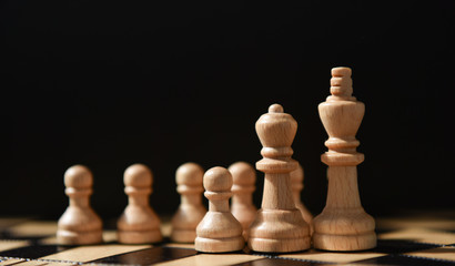 chess pieces on a chessboard on a black background