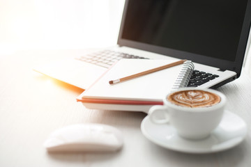 Top view of Laptop or Notebook Computers , pencil , and cup of coffee on white wooden table.