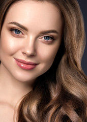 Naklejka premium Beauty long hair woman curly hairstyle natural makeup