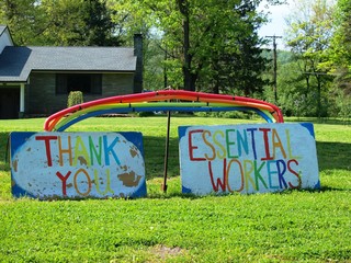 Bainbridge, NY / USA - May 27, 2020: A sign on a front lawn has a rainbow and says Thank You Essential Workers to everyone working during the Covid-19 outbreak in America during the Spring of 2020