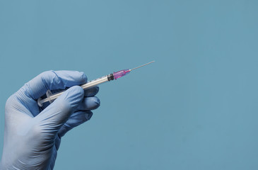 Doctor holding an injection with a needle, healthcare concept, covid 19 vaccine, covid 19 period