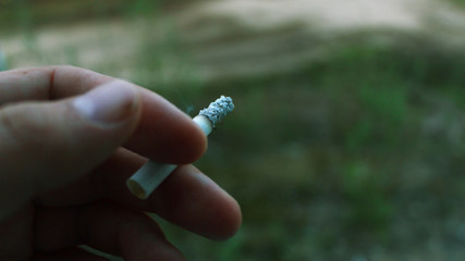 cigarette in hands
