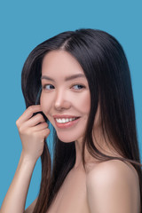 Fototapeta premium Beautiful woman with long and healthy hair smiling and looking great