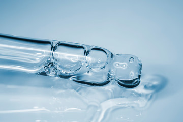 Cosmetic pipette with hyaluronic acid. Transparent gel with bubbles close-up. Gel cream or serum. A sample of a cosmetic product. Antibacterial gel.