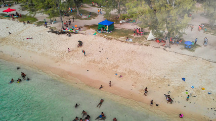 Swimmers near the shoreline, downward aerial view