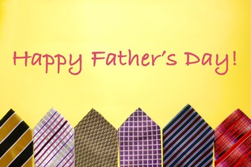 Assorted suit ties arranged in a lower third border on a yellow horizontal background 