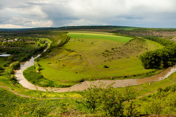 Beautiful summer landscape in Republic of Moldova. Green landscape. Spring Nature. Park with Green Grass and Trees. Grassy field and rolling hills. rural scenery. 