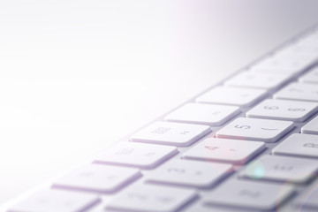 computer keyboard close up, detail of keys with light effect background