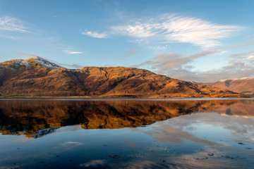 Fototapeta na wymiar autumn reflections on a still Loch Linnhe, Lochaber