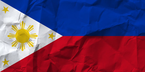 Philippines national flag on crumpled paper.