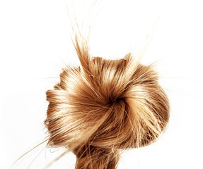 Healthy, shiny hair braided in a bun on a white background. Hair sample.