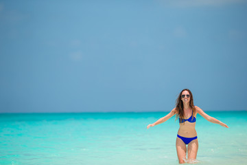 Fototapeta premium Young fashion woman in green dress on the beach