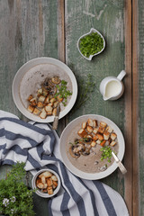 Creme soup with mushrooms in white bowl
