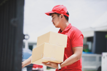 red delivery Man Holding Cardboard Box Ringing The Door Bell