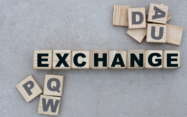 concept of the word EXCHANGE on cubes on a gray background